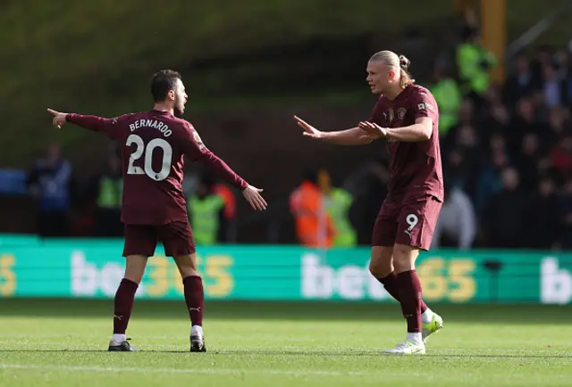 Erling Haaland of Manchester City interacts with Bernardo Silva