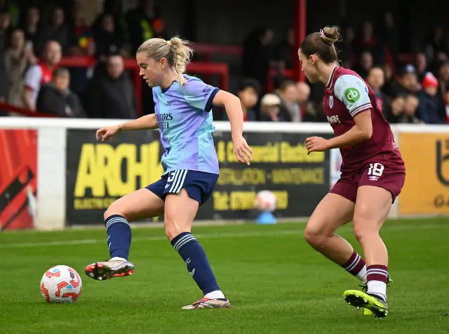 Alessia Russo of Arsenal controls the ball whilst under pressure from Anouk Denton