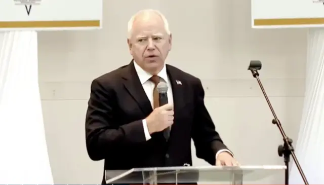 Tim Walz addresses a church congregation in Saginaw, Michigan