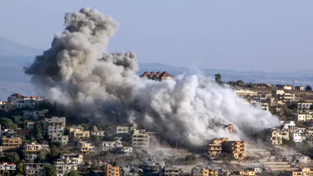 Smoke billows over Khiam in southern Lebanon above numerous buildings
