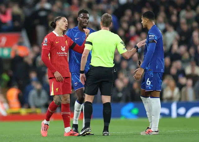 Darwin Nunez of Liverpool and Benoit Badiashile of Chelsea are spoken to by Referee