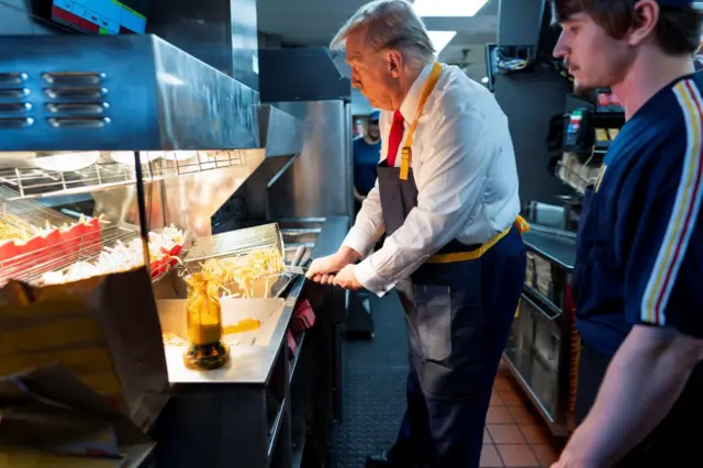 Trump works behind the counter during a visit to McDonald's in Feasterville-Trevose, Pennsylvania