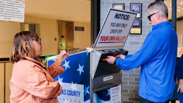 A man casting a ballot