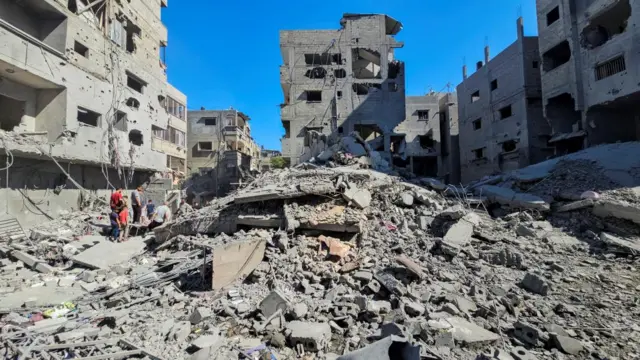 Palestinians gather at the site of Israeli strikes in Beit Lahia on Sunday