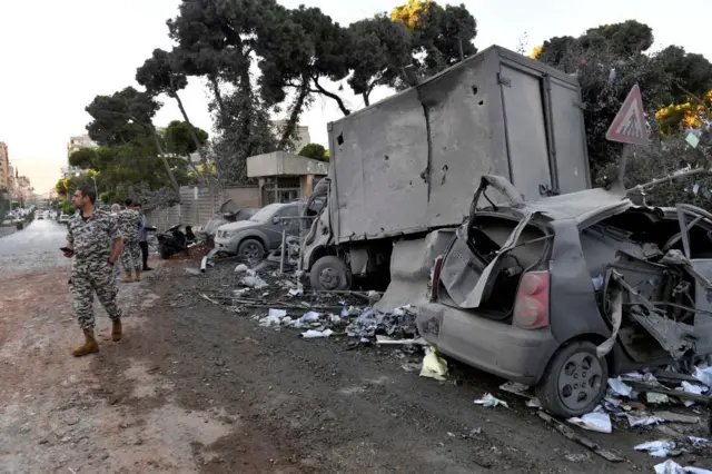 Lebanese soldiers stand at the site of an Israeli airstrike that targeted a branch of the Al-Qard Al-Hassan finance group in Al-Shiyah, Beirut,