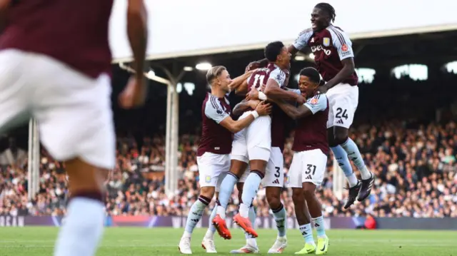 Aston Villa players celebrate after taking the lead against Fulham