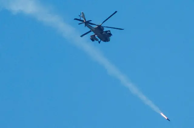 An Israeli Apache attack helicopter fires a missile towards southern Lebanon today