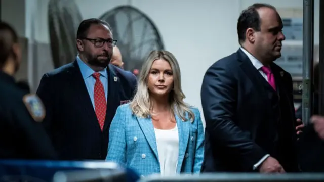 Karoline Leavitt (centre) pictured at a Manhattan criminal court during Donald Trump's fraud trial