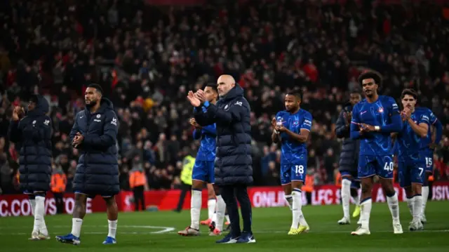 Chelsea players and manager applaud travelling fans after defeat at Anfield.