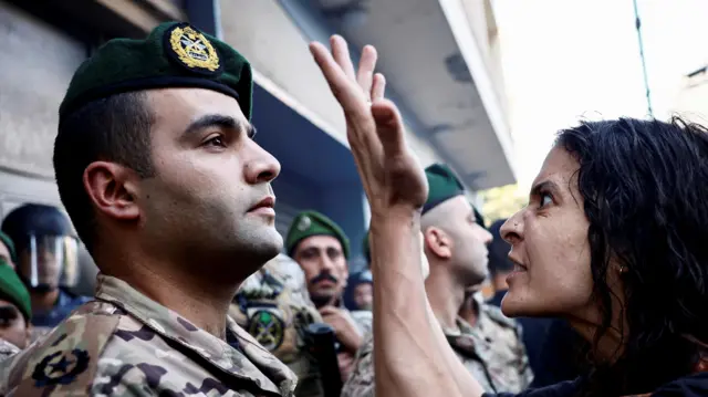 A woman reacts, as members of security forces attempt to evict displaced people from an old hotel, amid ongoing hostilities between Hezbollah and Israeli forces, in the Hamra neighbourhood of Beirut, Lebanon October 21