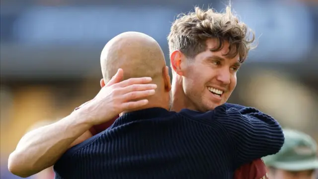 Pep Guardiola, Manager of Manchester City and John Stones of Manchester City celebrate