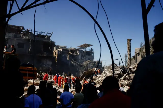 Rescuers search for survivors at the site of an Israeli strike near Rafik Hariri University Hospital