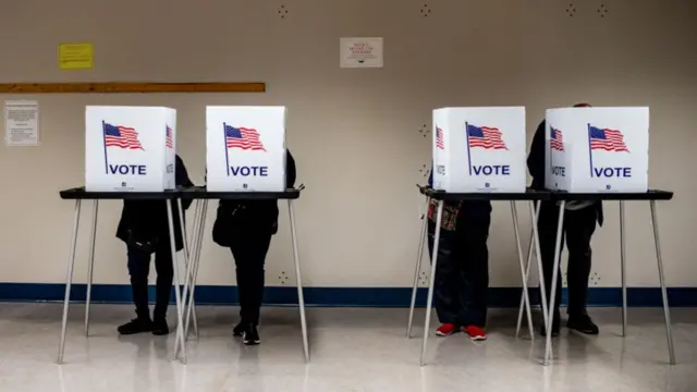 Voters cast their ballot during the first day of early voting at a polling station in Detroit, Michigan, US, on Saturday, Oct. 19, 2024.