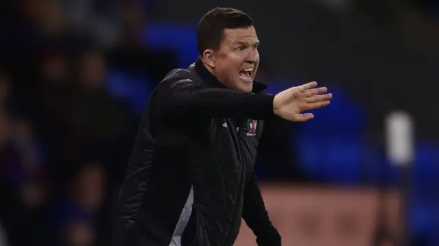 Exeter City manager Gary Caldwell shouts instructions