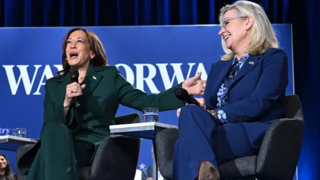 US Vice President and Democratic presidential candidate Kamala Harris (L) gestures toward former Representative Liz Cheney,