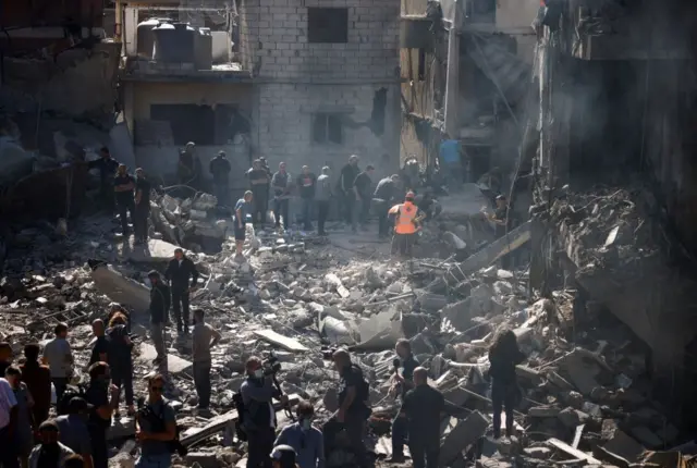 Rescuers search for survivors at the site of an Israeli strike near Rafik Hariri University Hospita