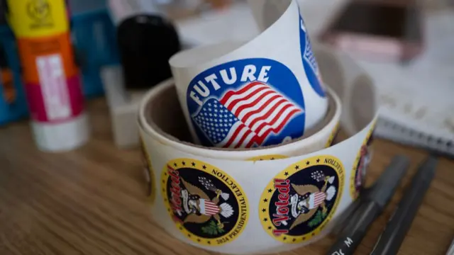 Stickers given to voters sit on a table at the Kenosha Municipal Building where an election official collects mail-in ballots from resident