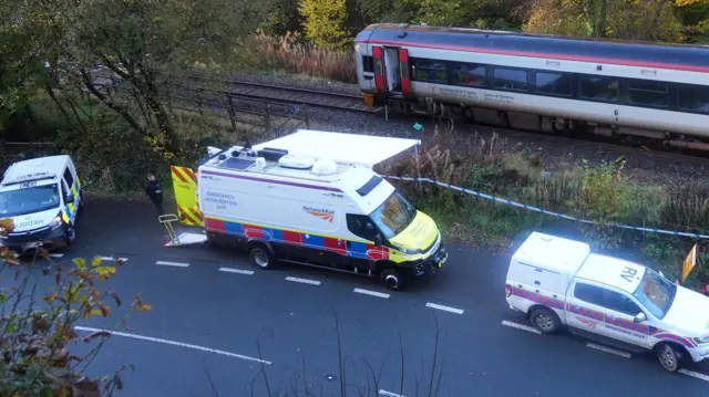 Picture of the police and network rail emergency vehicles at the scene