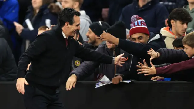 Aston Villa manager Unai Emery hi-fives the fans during the UEFA Champions League