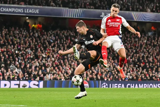 Shakhtar Donetsk's Ukrainian defender Valeriy Bondar tackles Arsenal's Belgian midfielder Leandro Trossard as they fight for the ball