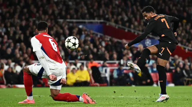 Shakhtar Donetsk's Eguinaldo shoots at goal as Arsenal's Gabriel Magalhaes reacts