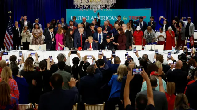 Latino community leaders pray for Republican presidential nominee and former U.S. President Donald Trump during a roundtable