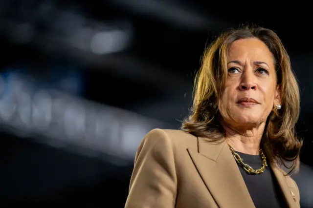 Kamala Harris, wearing a beige jacket, with a stern look on her face, at a campaign rally at the Rawhide Event Center in Arizona on 10 October