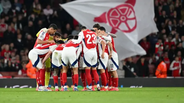 The Arsenal team huddle during the UEFA Champions League