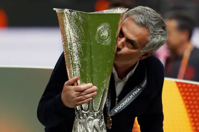 Jose Mourinho kisses the Europa League trophy