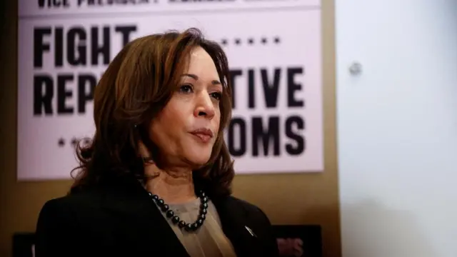 Kamala Harris stands in front of a reproductive rights sign