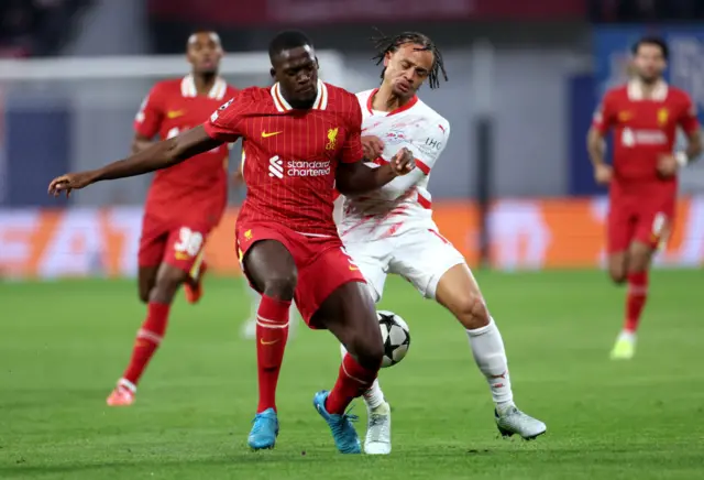 Ibrahima Konate of Liverpool battles for possession with Xavi Simons of RB Leipzig