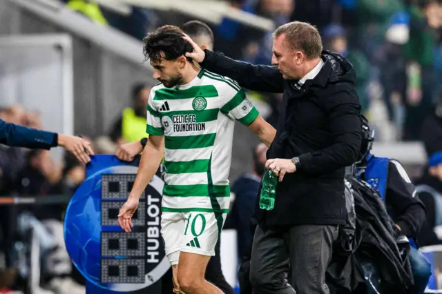 Nicolas Kuhn gets a word of appreciation from Brendan Rodgers