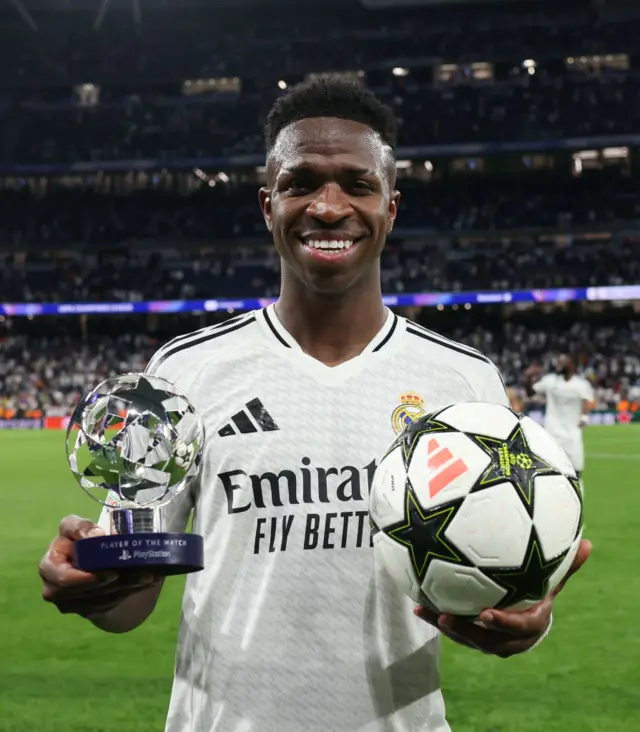 Vinicius Jr with his man-of-the-match trophy and the match ball