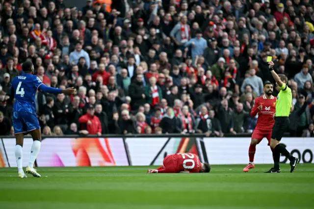 Liverpool striker Diogo Jota laying on the pitch injured