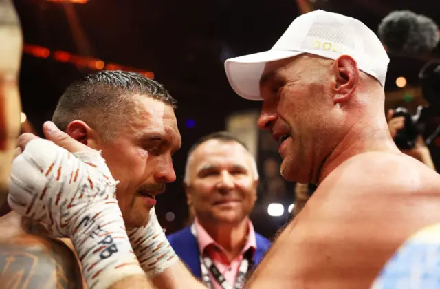 Tyson Fury and Oleksandr Usyk embrace in the ring