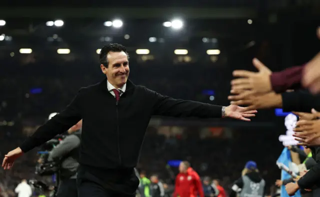 Unai Emery hi-fives fans at Villa Park