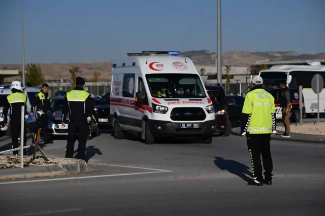 An ambulance and Turkish police officers are pictured near the scene