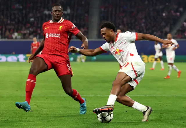 Ibrahima Konate of Liverpool is challenged by Lois Openda of RB Leipzig