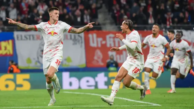 Benjamin Sesko of RB Leipzig celebrates with teammates after scoring