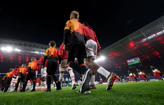 Players and mascots walk out prior to the UEFA Champions League match between RB Leipzig and Liverpool FC