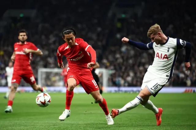 Timo Werner crosses the ball past AZ Alkmaar's Japanese defender Seiya Maikuma