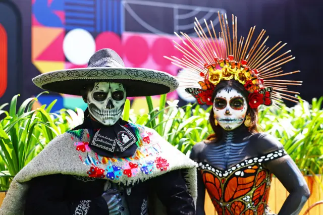 Performers dressed up as the Day of the Dead