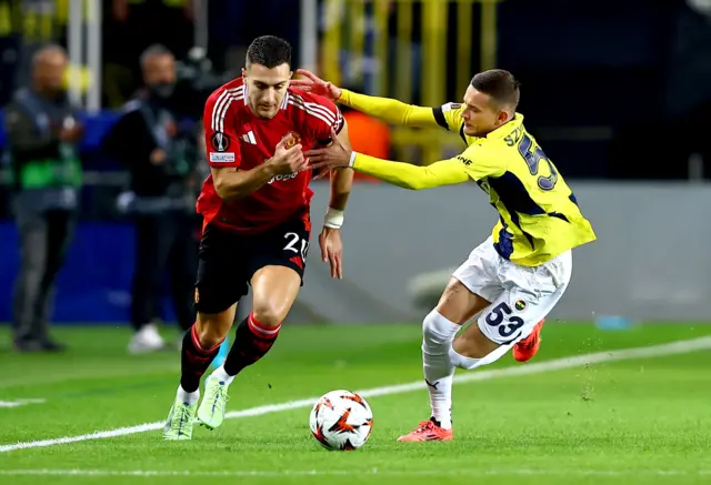 Sebastian Szymanski of Fenerbahce in action against Diogo Dalot of Manchester United