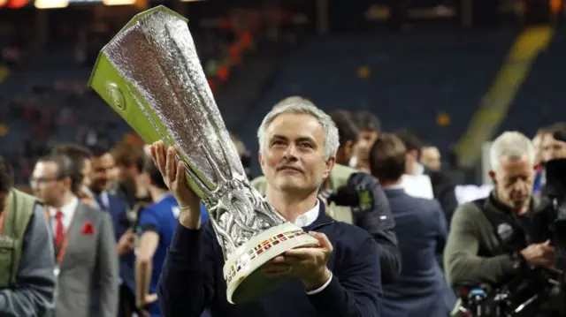 Jose Mourinho holds the Europa League trophy in 2017.