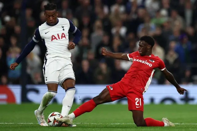 Destiny Udogie is tackled by AZ Alkmaar's Dutch forward Ernest Poku