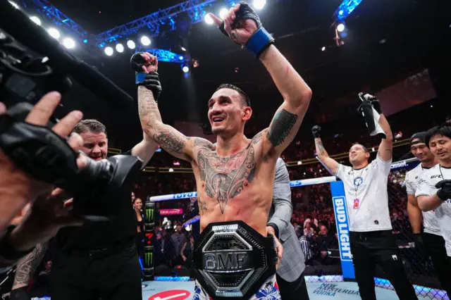 Max Holloway celebrates winning the BMF title after beating Justin Gaethje at UFC 300 in April