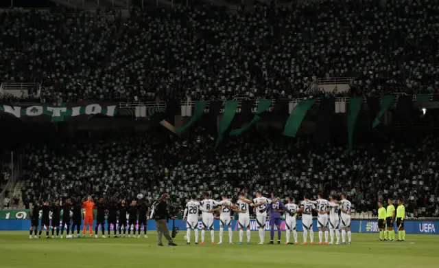 Players stand side by side for a minute's silence