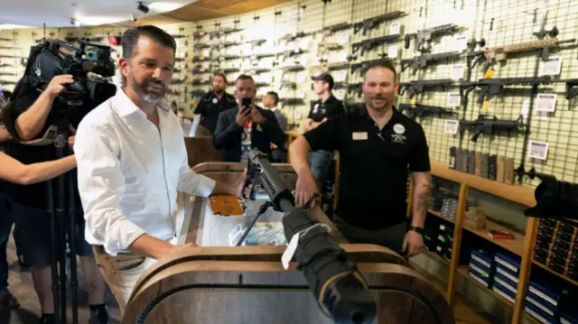 Trump jr looking at a gun