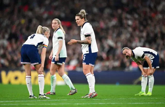 Millie Bright talking to team-mates