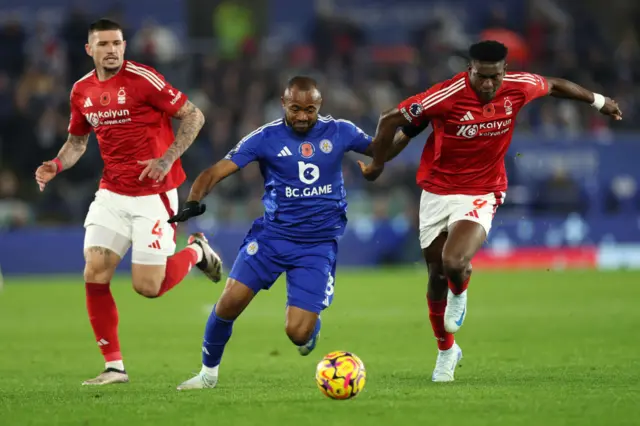 Jordan Ayew of Leicester City battles for possession with Taiwo Awoniyi